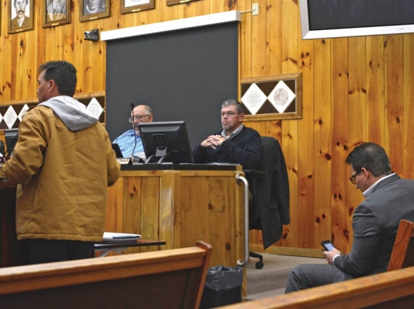 Former Principal Chief Patrick Lambert (left) tells Tribal Council his concerns about the payouts as Principal Chief Richard Sneed (far right) sits in the front row of Council chambers in January. File photo