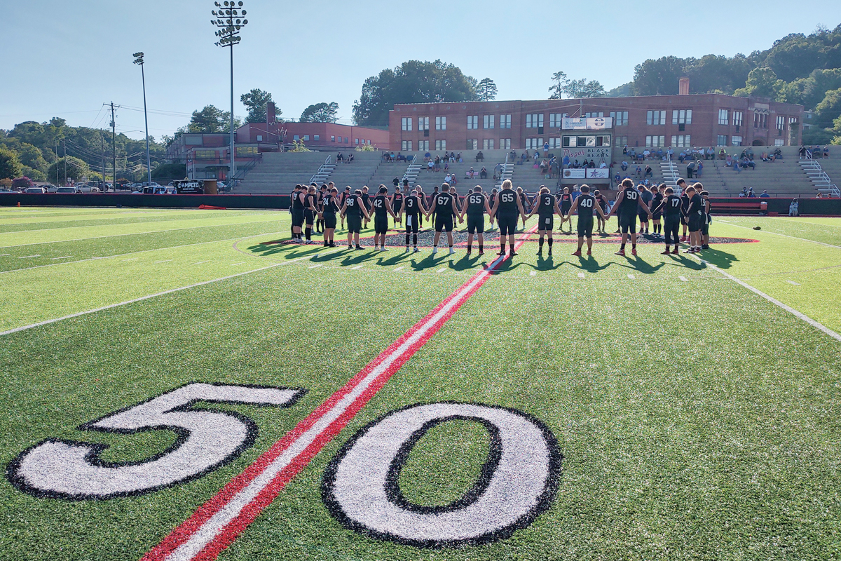 Before the start of the Pisgah High School football season opener last week, the entire Black Bears team gathered together at the 50-yard line.  Garret K. Woodward photo