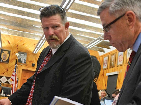 Robert Saunooke (left) talks with Patrick Lambert’s attorney Scott Jones during the May 2017 impeachment hearing. Holly Kays photo 