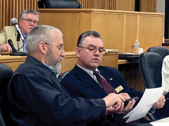 Macon County commissioners Paul Higdon (left) and Karl Gillespie confer during a meeting March 10. Lilly Knoepp photo