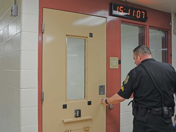 Detention Officer Ledford shows how automated technology helps ensure staff is adhering to protocol that requires them to check on inmates twice an hour. Jessi Stone photo