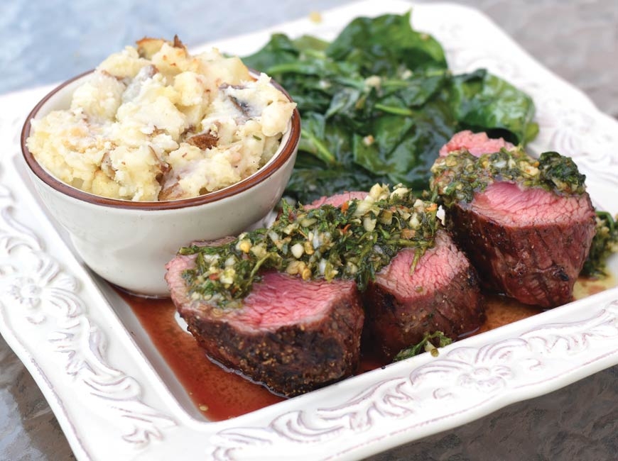 A main entrée at Rivers &amp; Rails Tavern: steak medallions with chimichurri sauce, roasted garlic mashed potatoes and garlic lemon wilted spinach.