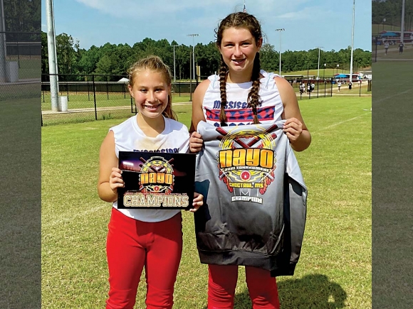 Pitcher Suri Watty (left) and catcher Carley Teesateskie show off their tournament title. Sasha McCoy Watty photo