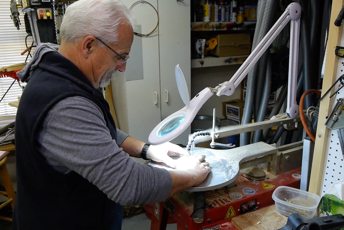 Retired park ranger Mike Meldrum works in his garage shop to create an old-fashioned wooden toy, which he will then donate for sale in the Cades Cove Visitor Center. 