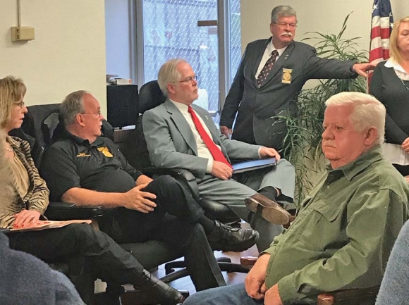 Swain Sheriff Curtis Cochran and his attorney David Sawyer (left) speak to the Swain County Board of Elections during a preliminary hearing held for Cochran’s candidate challenge filed by Jerry Lowery (right). 