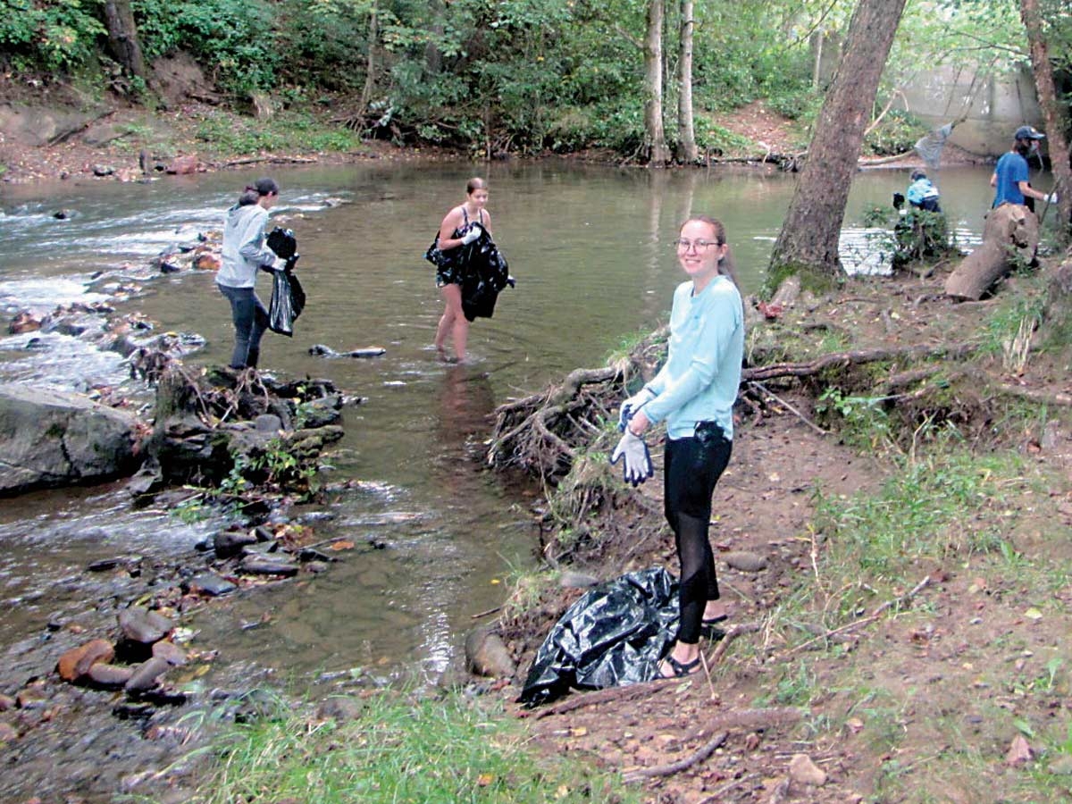 Students from Haywood Community College and Haywood Early College collect trash in Richland Creek. Haywood Waterways Association photo