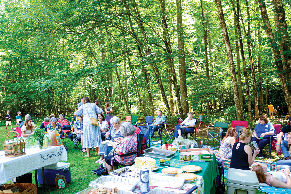 The tables are still full of food as reunion attendees spread out on the lawn to eat and enjoy each other’s company. Holly Kays photo 