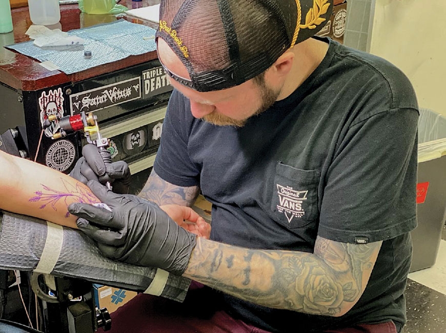 Robbie Crisp working on a new arm piece for a client at Born and Raised Tattoo parlor in Sylva. (photo: Garret K. Woodward) 