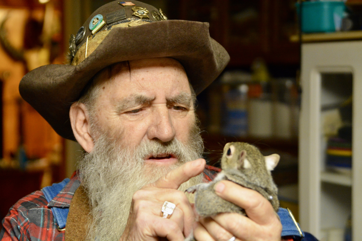 Herbert &quot;Cowboy&quot; Coward disciplines his unruly pet squirrel, named Angel, at his home near Clyde in 2019.