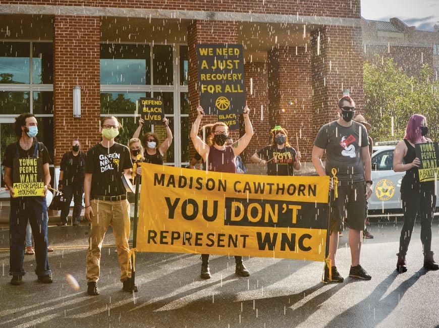 Demonstrators braved a brief downpour to advocate for the Green New Deal on                 Sept. 9 in Sylva. Cory Vaillancourt photo
