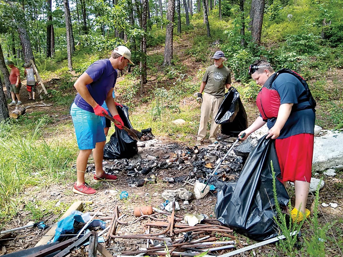 Volunteers pick up a trashed campsite at Fontana Lake. Donated photo