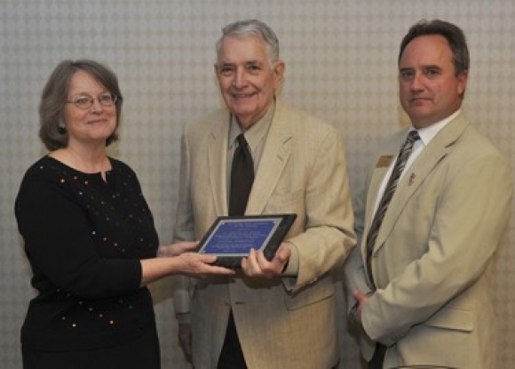 Alfred Douglas “Doug” Reed of Cullowhee (center) is congratulated by Robin Denny, president of the College News Association of the Carolinas, and Bill Studenc, senior director of news services at Western Carolina University, after being named recipient of CNAC’s Lifetime Membership Award.