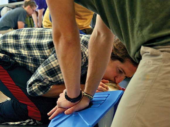 A Landmark Learning student practices CPR. File photo