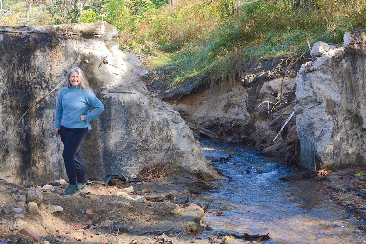 American Rivers Southeast Conservation Director Erin McCombs stands next to the recently cut notch in the Beaverdam Creek dam. Holly Kays photo