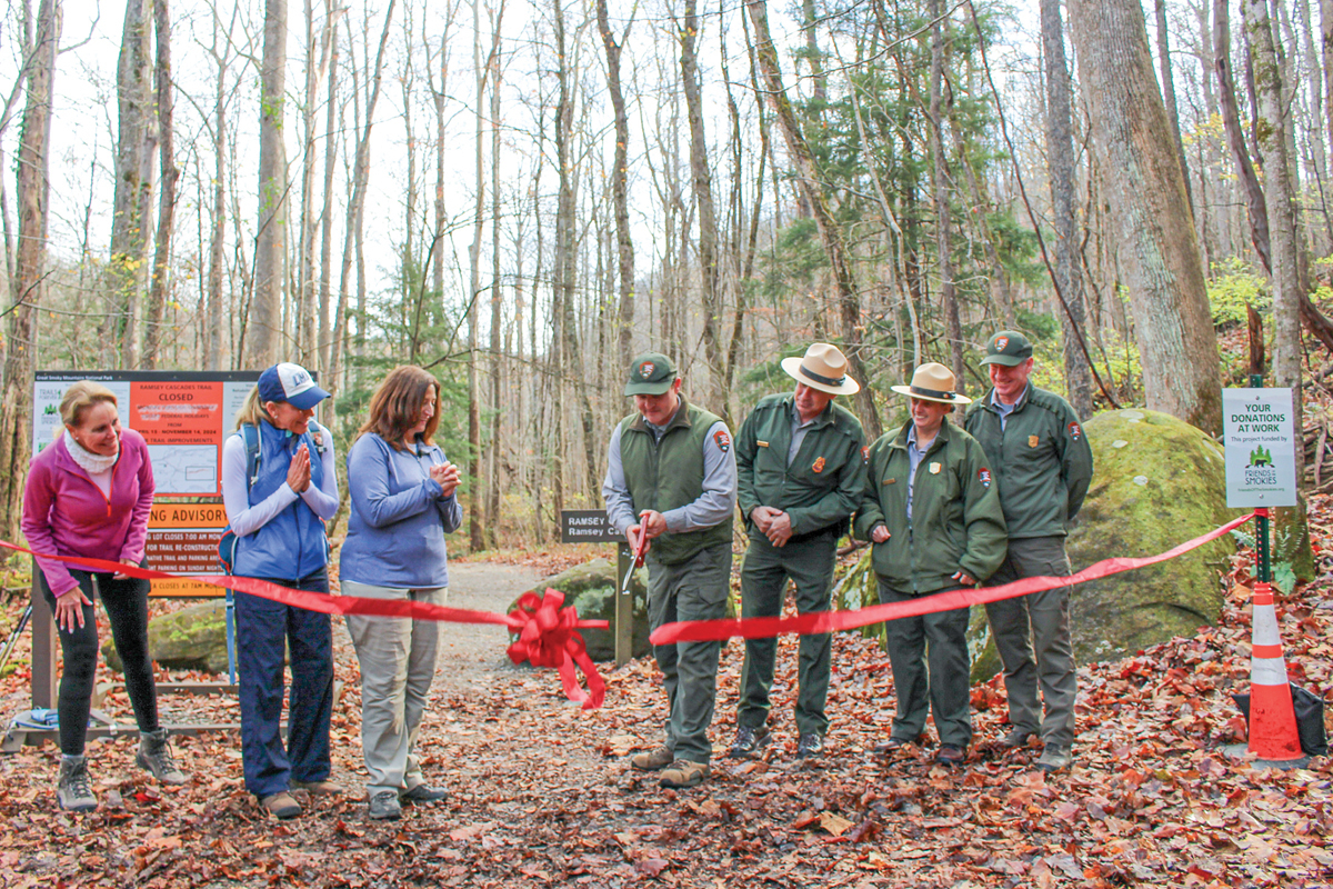 Josh Shapiro, Trails Forever supervisor, cuts the ribbon for Ramsey Cascades Trail. NPS photo