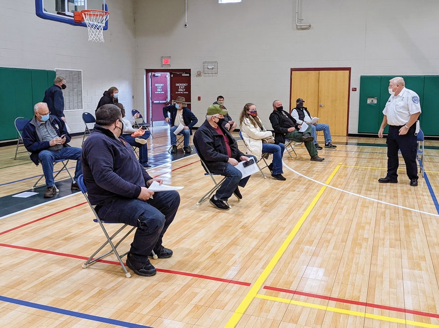 Vaccine recipients wait for the 15-minute observation period required during a clinic for first responders Jan. 15. 