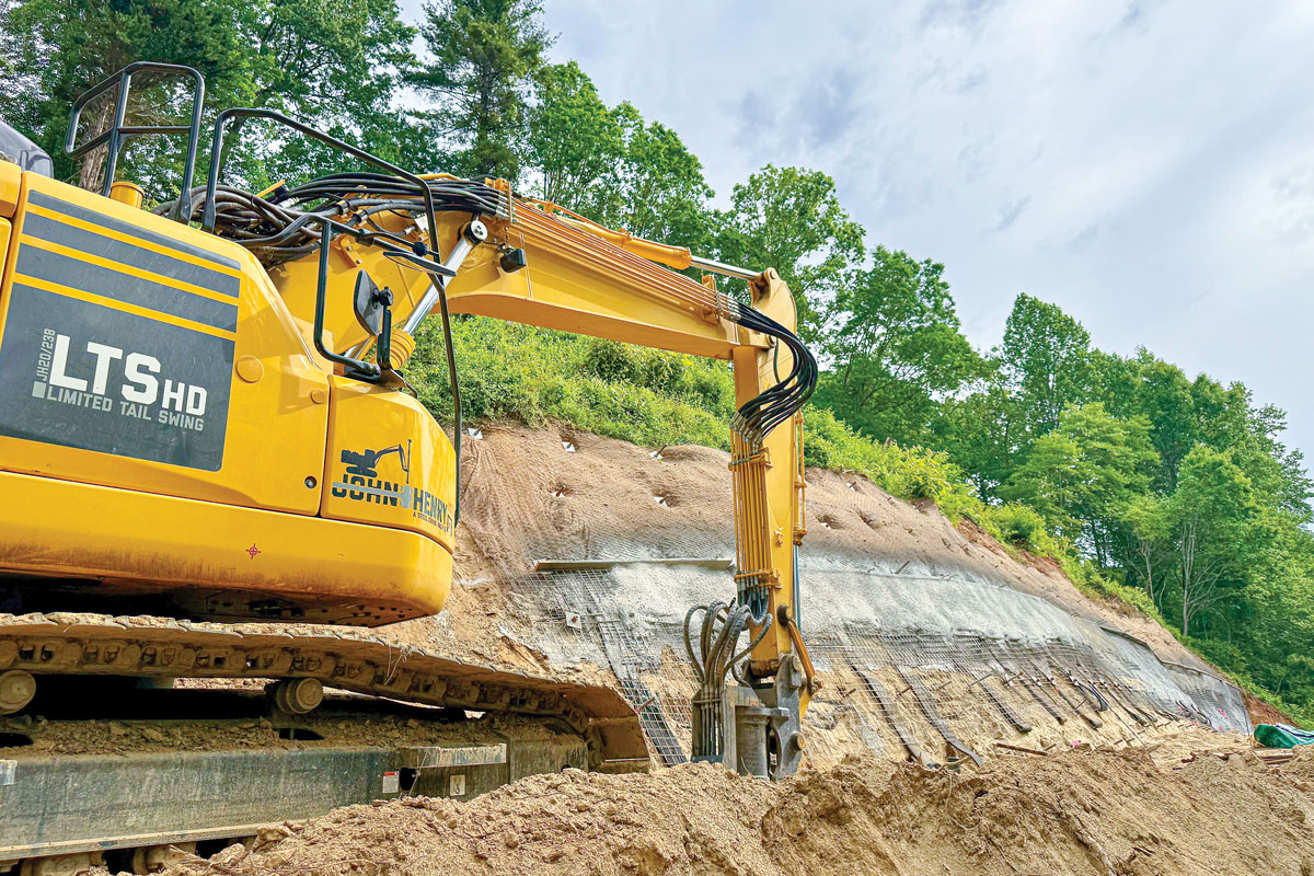 Workers are almost done installing long metal rods, wire mesh and mortar to stabilize the slope. Cory Vaillancourt photo