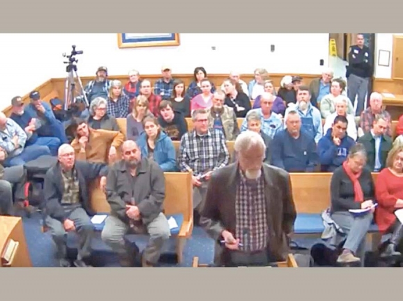 Macon County Planning Director Jack Morgan speaks to commissioners regarding the proposed changes to the county grading license program in front of a packed room during a Jan. 9 public hearing. Screenshot from meeting