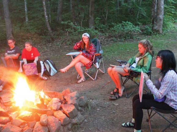 Girls gather around a bonfire for some end-of-day activities. Donated photo
