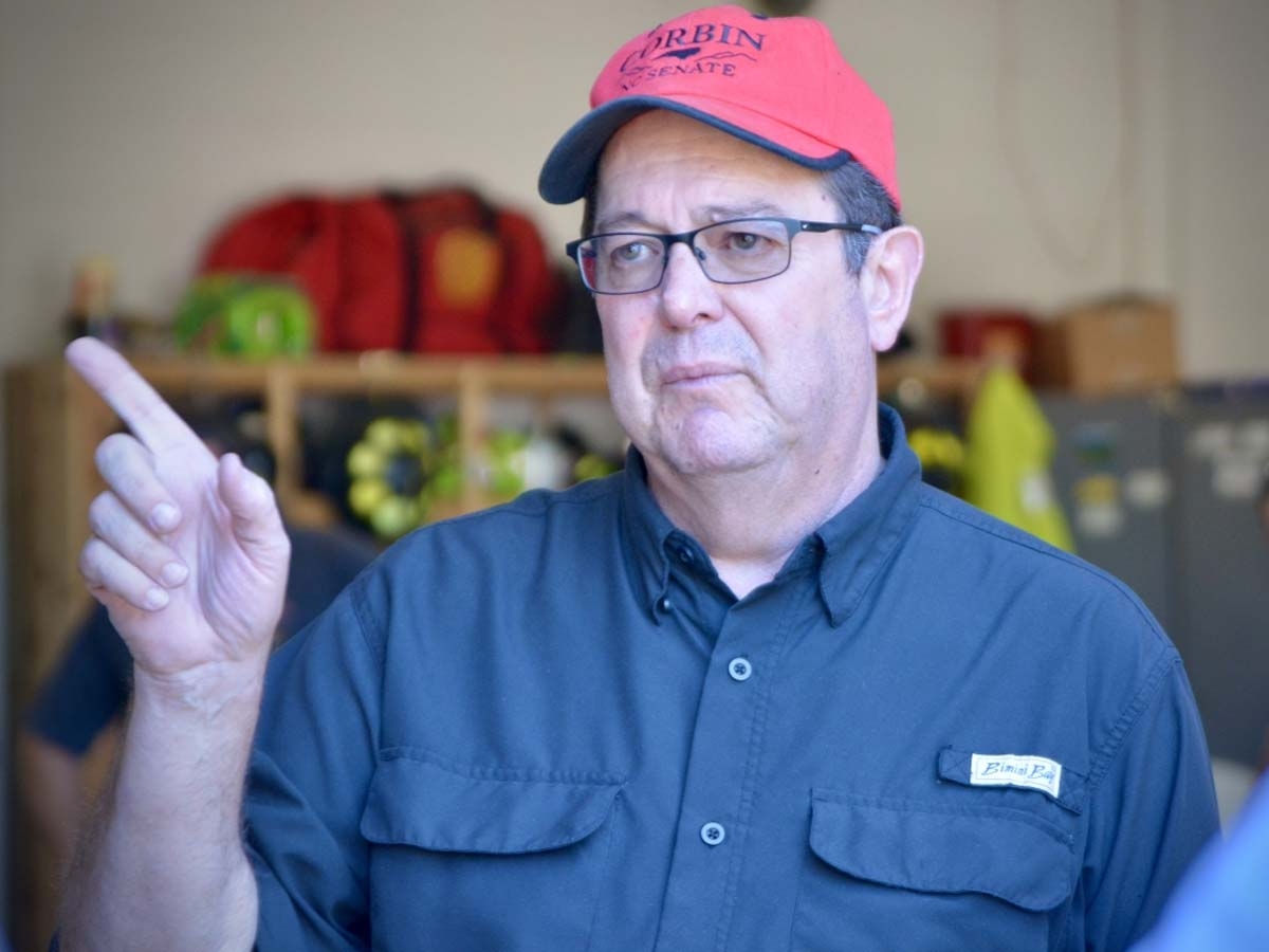 Sen. Kevin Corbin speaks at the Cruso Fire Department in the aftermath of deadly flooding this past summer.