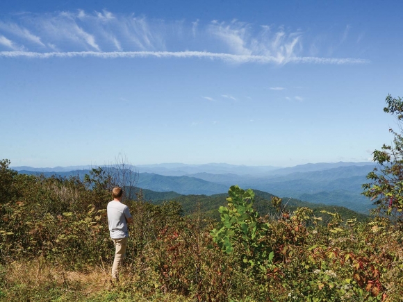 In a 2018 photo, Jordan Smith of Mainspring Conservation Trust looks out from a 5,462-foot view atop the Blackrock property. Holly Kays photo