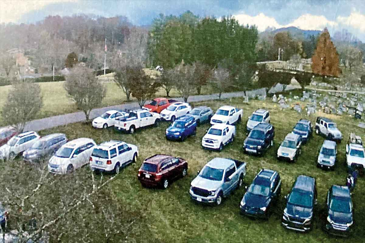 Dozens of cars sit on the grass at Green Hill Cemetery last Halloween. 