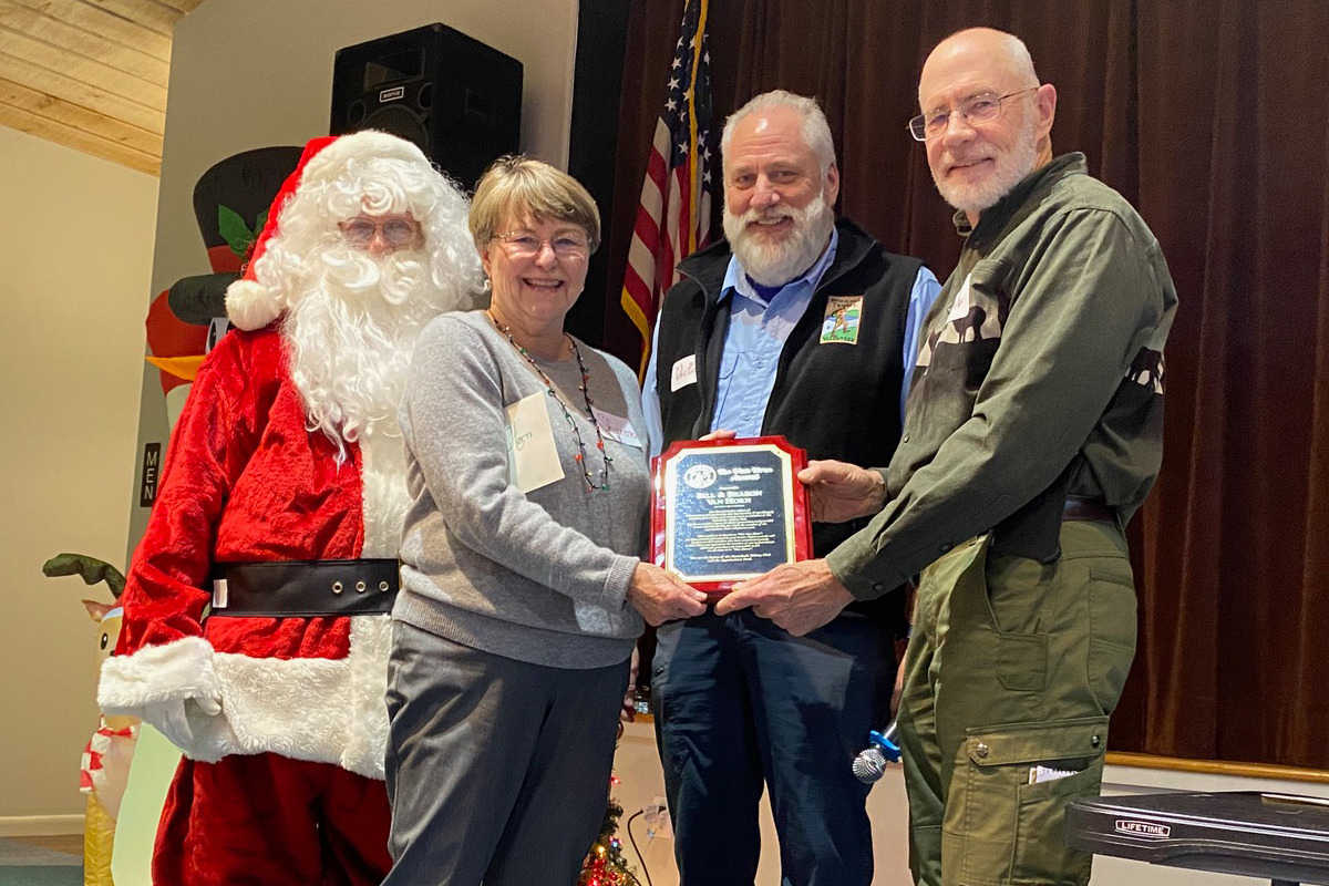 Bill (far right) and Sharon (second from left) Van Horn stand with Santa Claus and NHC President Victor Treutel to receive their award. NHC photo