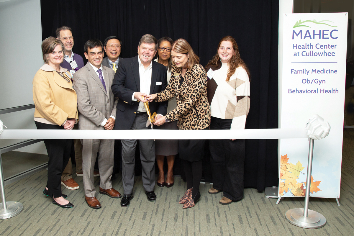 A group consisting of (from left) Dolly Pressley Byrd, Dr. Ernesto de la Torre, Casey Cooper, C.Y. Wang, Dr. William Hathaway, Carol Burton, Kelli Brown and Ashley Tickle cut the ribbon at MAHEC’s new Cullowhee facility. 