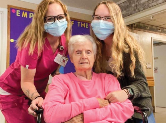 Skyland Care Center staff members pose for a picture with a resident.