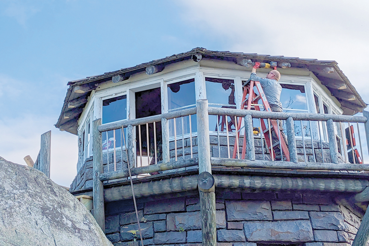 Forever Places crew member John Smith removes rotten rafter tail sections from the Mt. Cammerer Fire Tower. Holly Kays photo