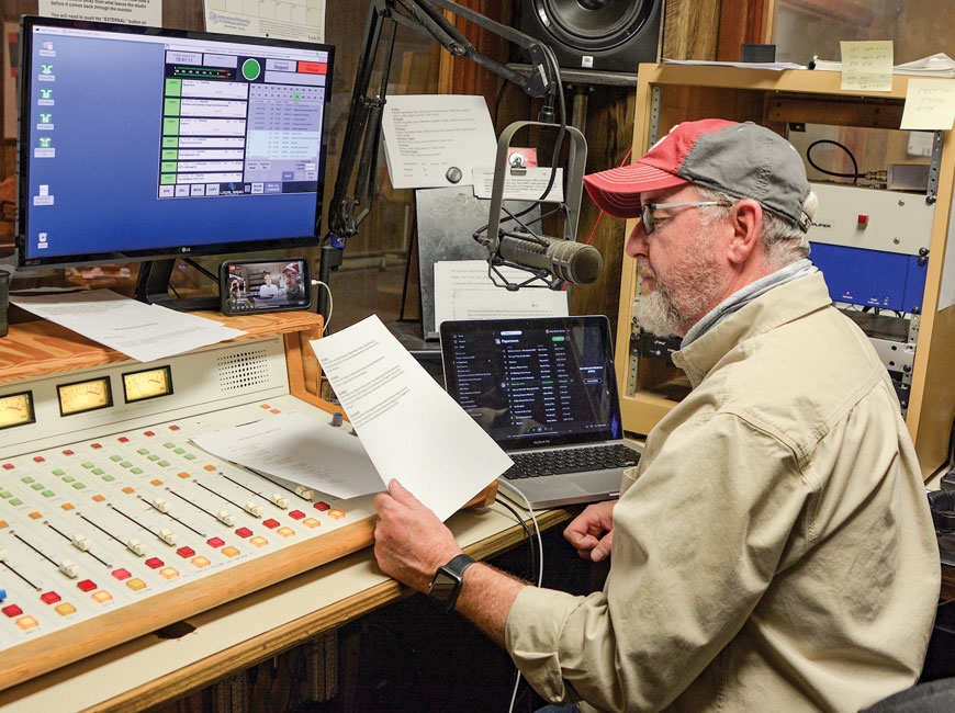 Bluegrass legend Tim Surrett behind the microphone of WPTL during his twice-weekly show ‘Papertown Roots Radio.’ (photo: Garret K. Woodward)