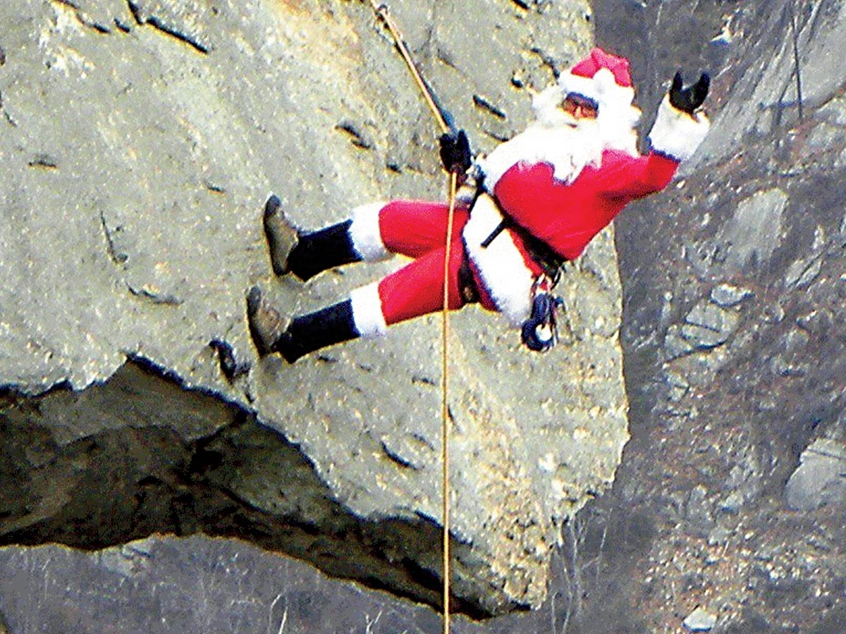 Santa Claus prepares to rappel down Chimney Rock. Donated photo