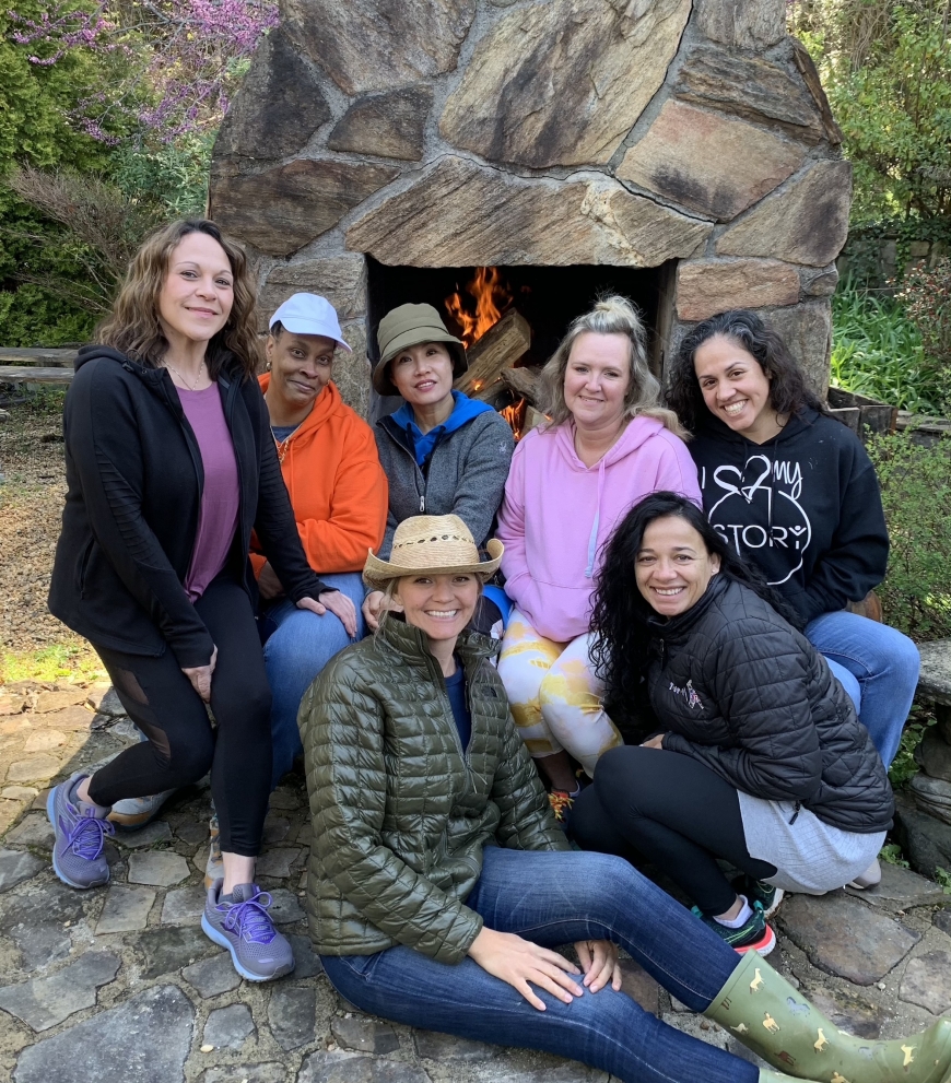 Participants pose for a quick photo by the Franklin-based Special Liberty Project’s outdoor fireplace with co-founder Jessica Merritt (sitting) during SLP’s first monthly Vitality Retreat for Gold Star Widows.