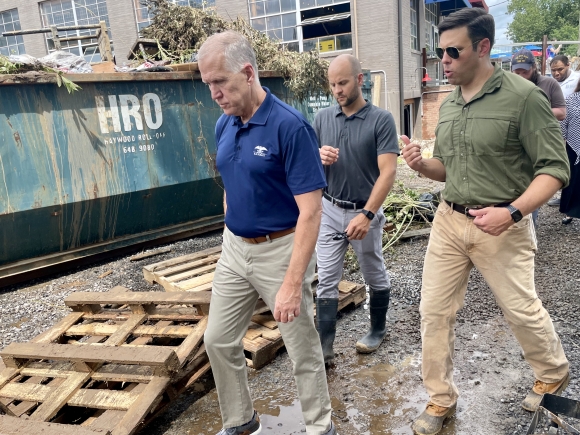 Sen. Thom Tillis (left) looks over damage at BearWaters Brewing with Canton Town manager Nick Scheuer (center) and Mayor Zeb Smathers (right).