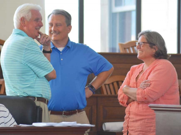 Waynesville Planning Board Vice Chairman Danny Wingate (left to right), Chairman Patrick McDowell and Development Services Director Elizabeth Teague chat before a meeting July 30. Cory Vaillancourt photo. 