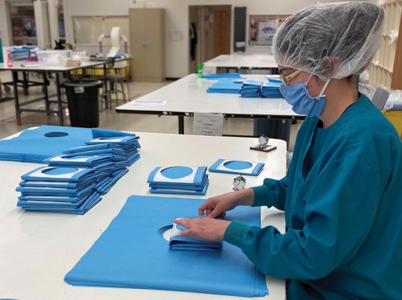A Webster Enterprises employee works to process drapes that will be used to treat COVID-19 patients worldwide. Webster Enterprises photo