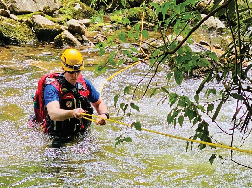 Kyle James, field team lead for Haywood Search and Rescue, carefully crosses a tributary of the West Fork Pigeon River. Nancy East photo 