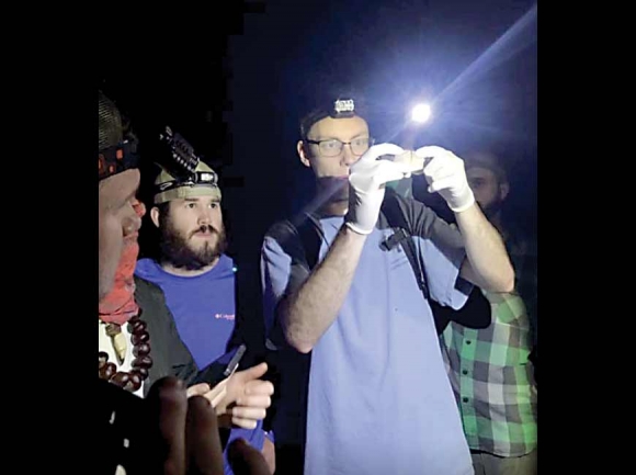 Current HCC student Lucas Evanko (left) watches as Blake Ledbetter, a former HCC student who now works as a bat technician, holds a bat. Donated photo