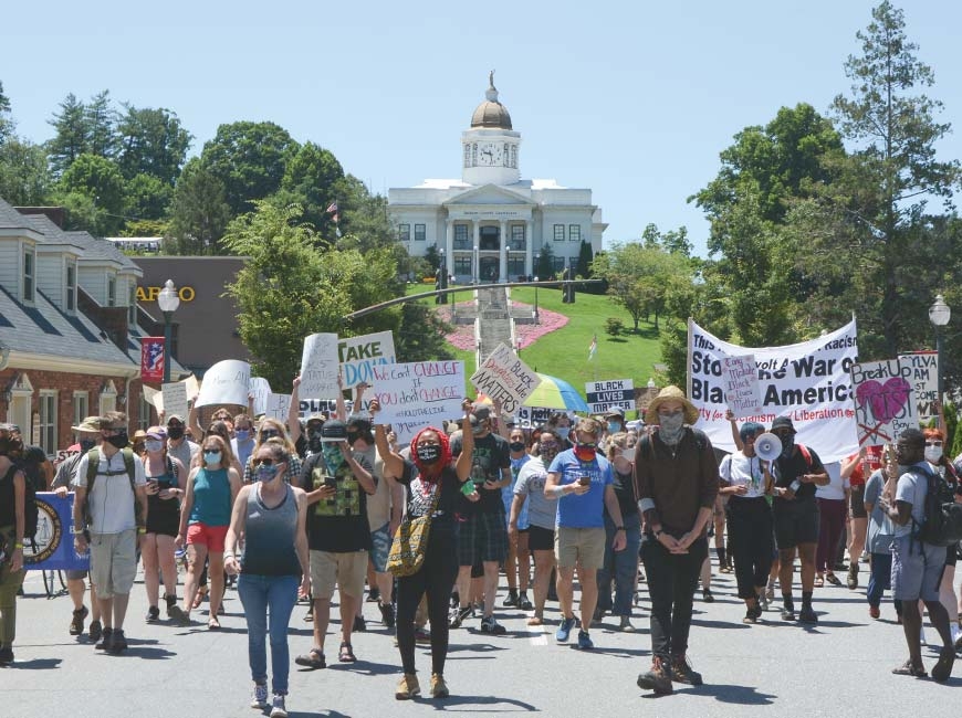 Protestors took to the streets July 11 to show their opposition to the Confederate solider statue on the hill below Sylva&#039;s historic courthouse, now the Jackson County Public Library.