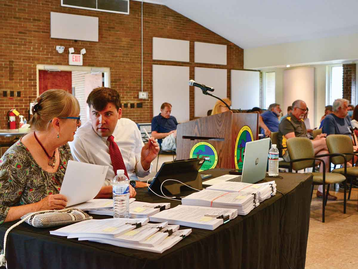 Lake Santeetlah Councilmember Diana Simon (left) speaks with her attorney, John Noor, before presenting voter challenges to the Graham County Board of Elections on July 7. Cory Vaillancourt photo