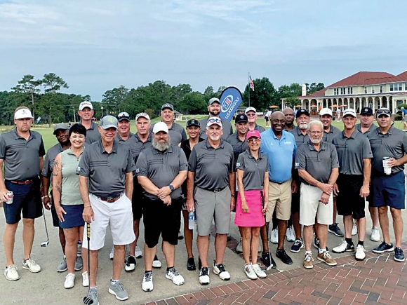 Team Members of Harrah&#039;s Cherokee Casinos join Phil Ford, honorary chairperson of N.C. Beautiful and former North Carolina Tar Heel basketball player and coach, for a group photo during the 35th Annual Golf Classic. Donated photo 