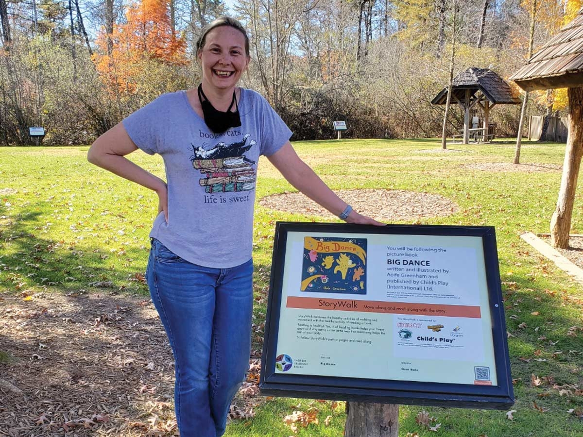 Librarian Serenity Richards installs a new page of ‘The Big Dance.’ Donated photo