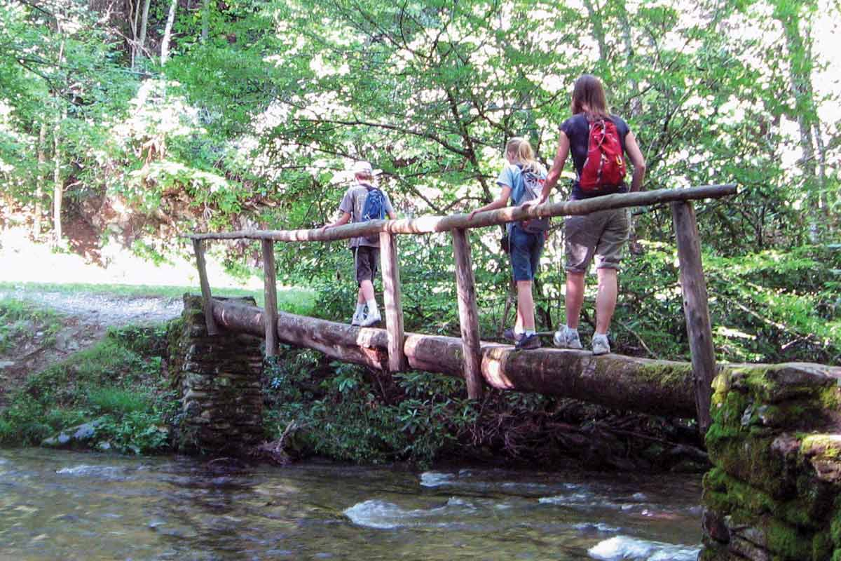 Hikers cross a creek on the Boogerman Trail. File photo