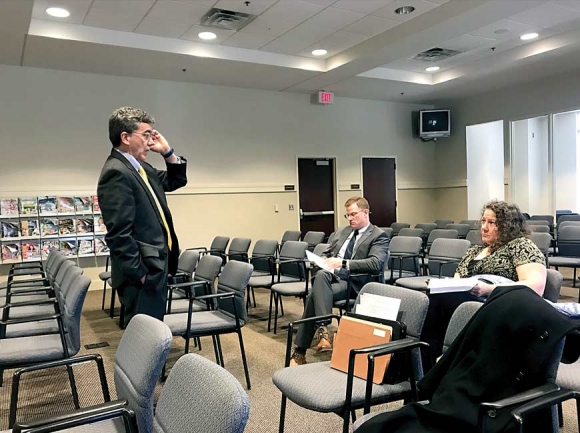 Tom Maher, executive director for Indigent Defense Services Office of North Carolina, speaks to lawyers Brad Ferguson and Karla Wood about the pretrial release program. Jessi Stone photo 