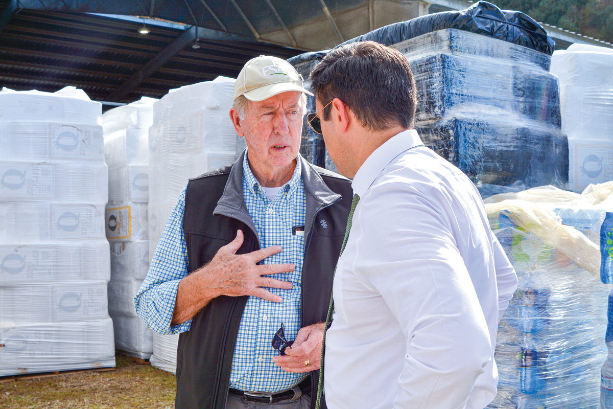 North Carolina executive director for the U.S. Department of Agriculture’s Farm Service Agency Bob Etheridge (left) chats with Canton Mayor Zeb Smathers at the WNC Regional Livestock Center on Oct. 31. Cory Vaillancourt photo