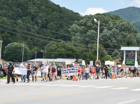 More than 100 BLM demonstrators (left) marched down Soco Road on Aug. 1. Garret K. Woodward photo