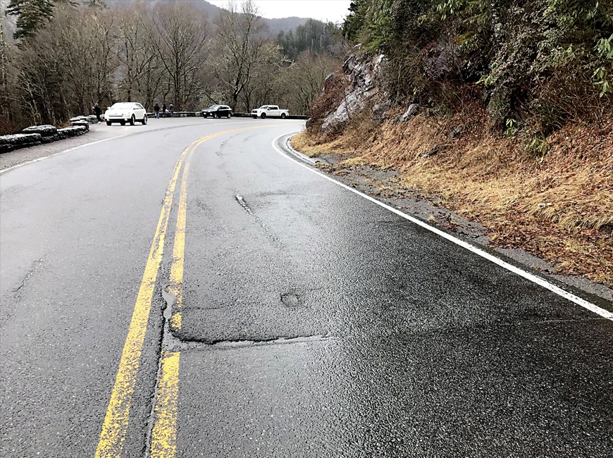 Cracks and bumps in the road show the need for repaving. NPS photo