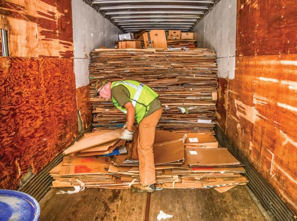 Richard Greene helps sort cardboard at the Cartoogechaye recycling center in Macon County. Bob Scott photo