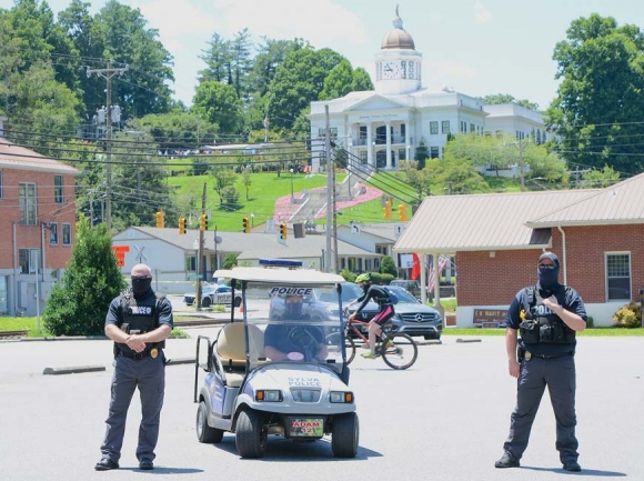 Masked police officers monitor the protest event at Bridge Park. Holly Kays photo