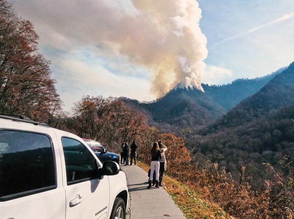 Smoke billows from the Chimney Tops during the early days of the fire that would eventually sweep a path of destruction through Gatlinburg and Pigeon Forge. NPS photo